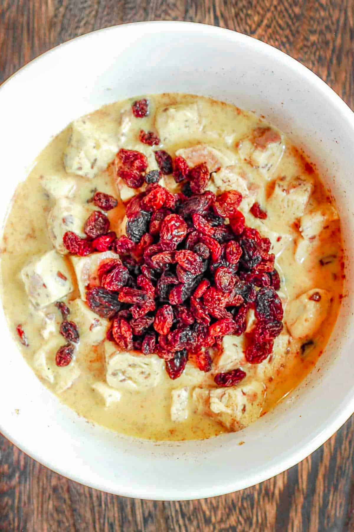 cranberries mixed into the dough on top of apple cinnamon roll cake