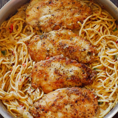 Chicken breasts on spaghetti in a pan