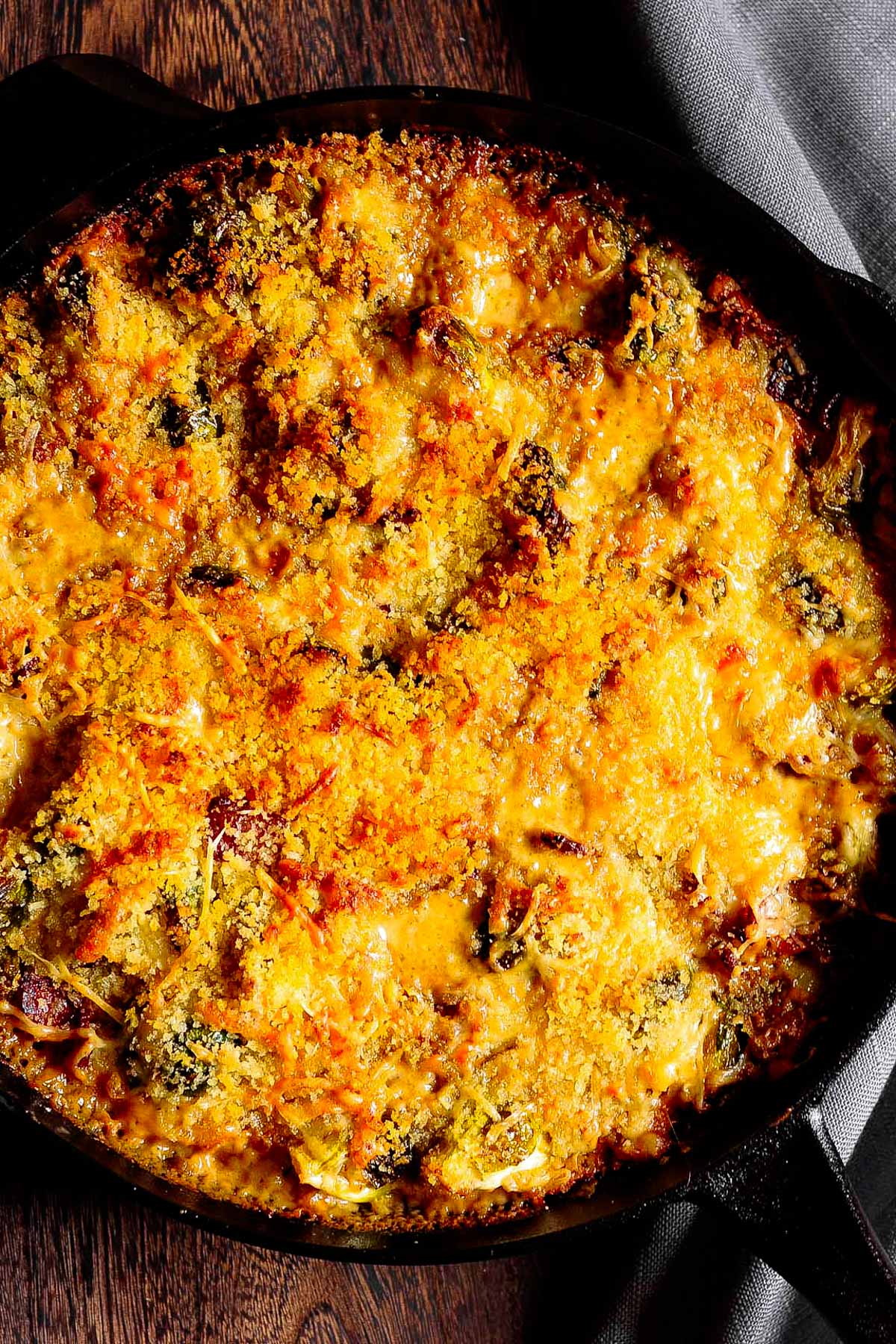 brussels sprouts and bacon gratin with gruyere cheese right in the cast iron skillet
