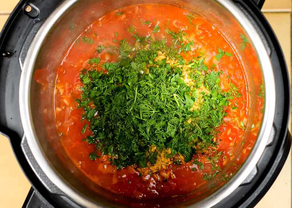 Sauce with dill weed inside instant pot for shrimp orzo recipe