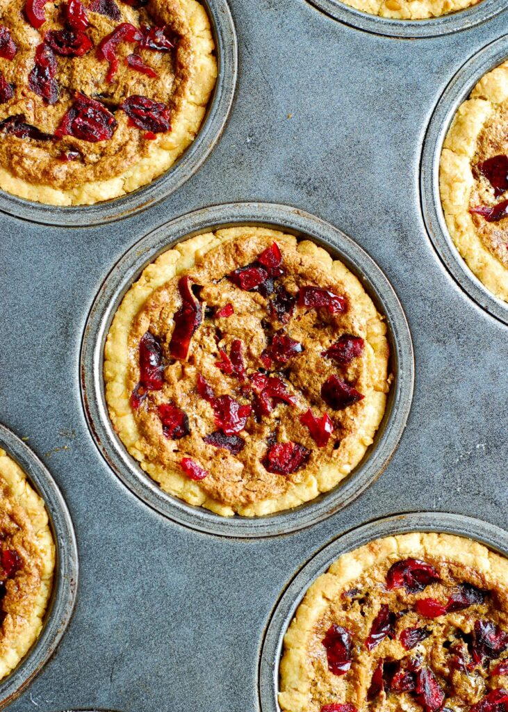 Mini Cranberry Pecan Pies in a muffin pan
