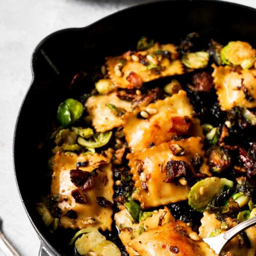 Brussels Sprouts and Ravioli with Maple Pecans and Pine Nuts in large skillet