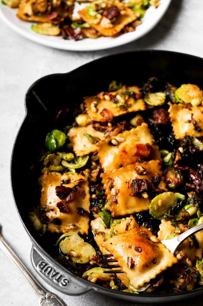 Brussels Sprouts and Ravioli with Maple Pecans and Pine Nuts in large skillet