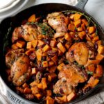 sweet potatoes and chicken in a cast iron pan