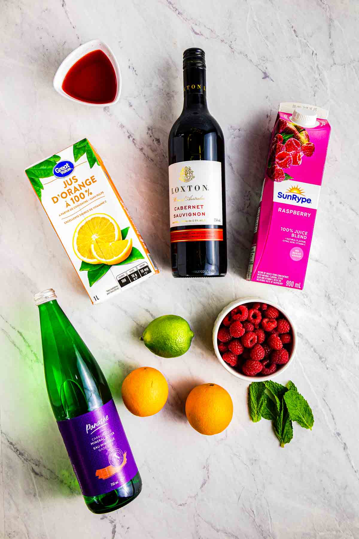 Red Sangria Ingredients: dry red wine, pomegranate juice, 2 oranges, mint, fresh raspberries, orange juice