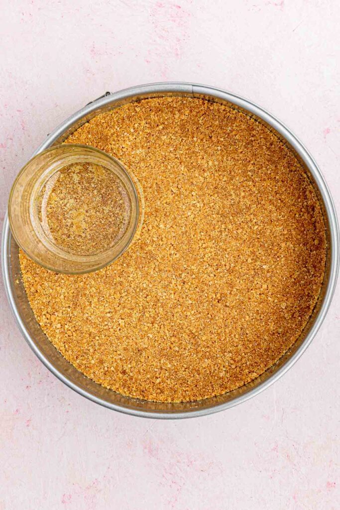 crashed graham crackers sugar and butter pressed into the spring form pan with the bottom of glass measuring cup