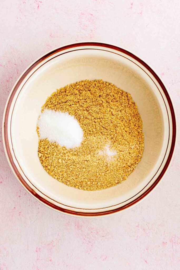crushed graham crackers in the bowl with sugar