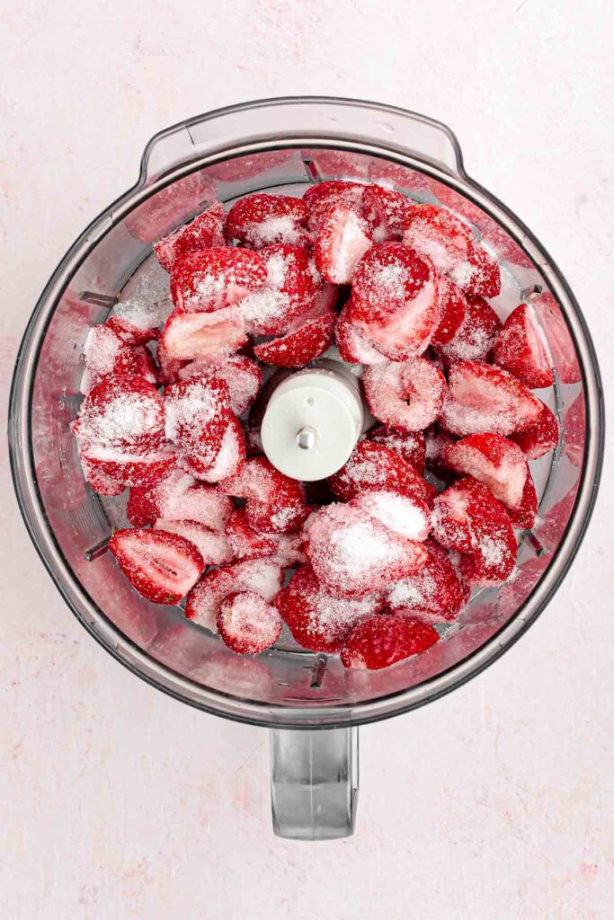 fresh sliced strawberries with sugar in the food processor