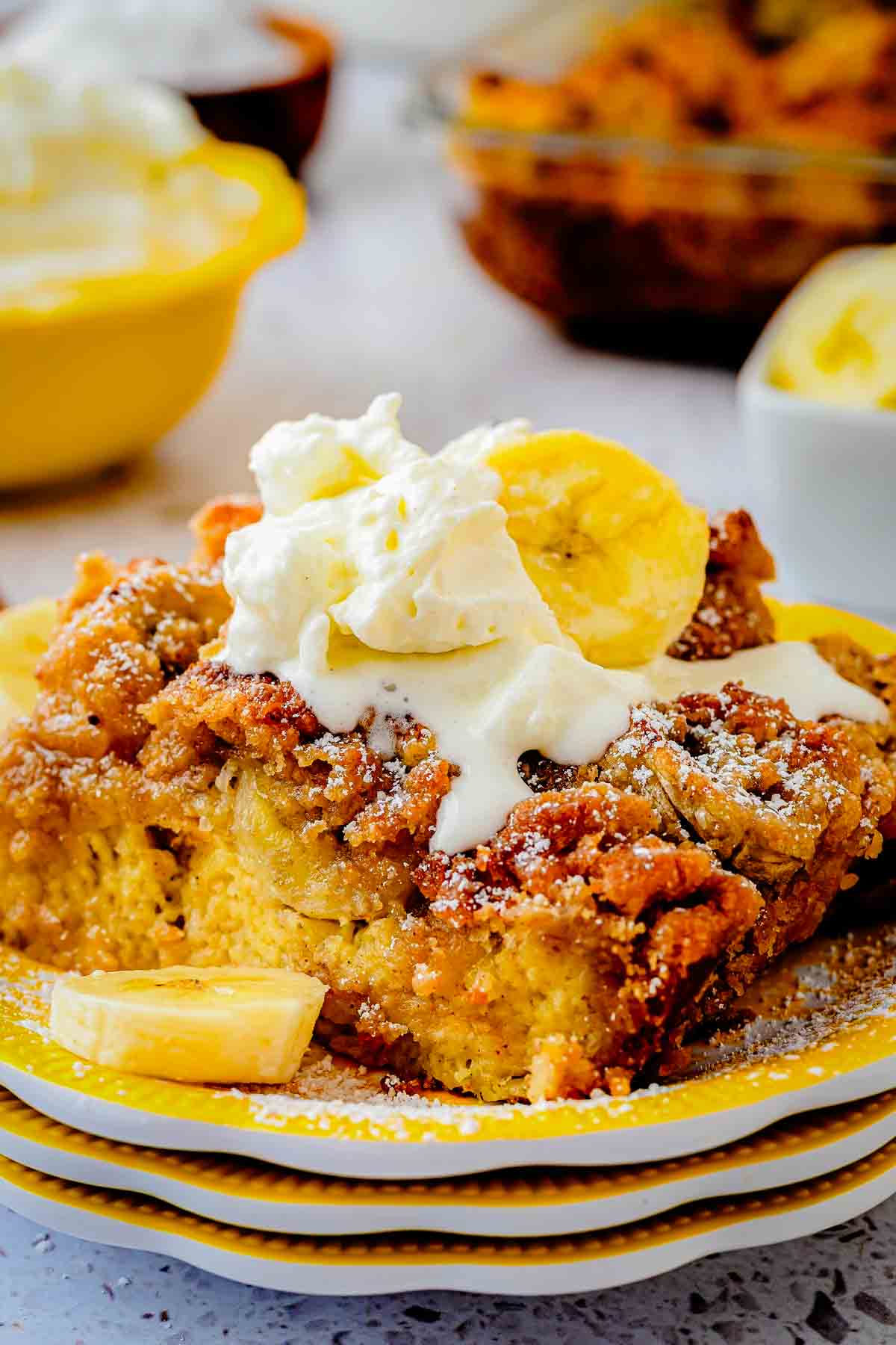 Banana French Toast Casserole with streusel topping and syrup poured on top