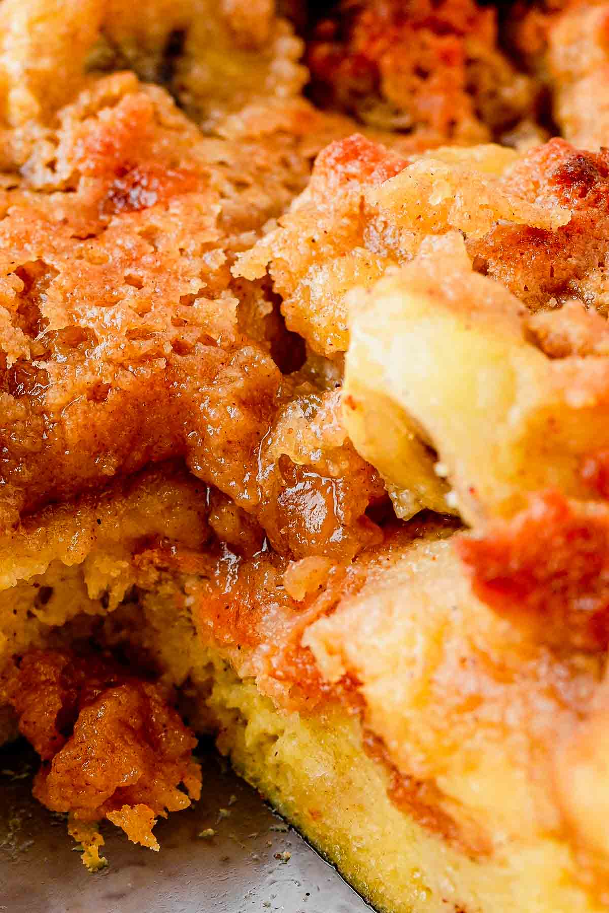 Close up of Banana French Toast Casserole with fresh banana slices and syrup poured on top
