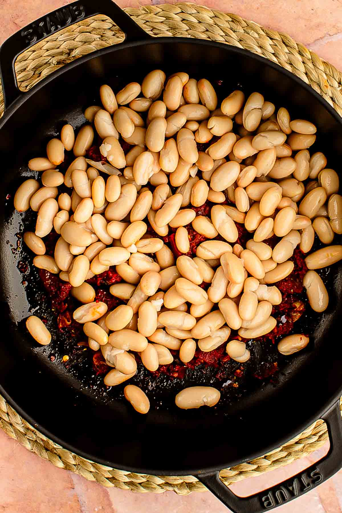 adding butter beans to the skillet
