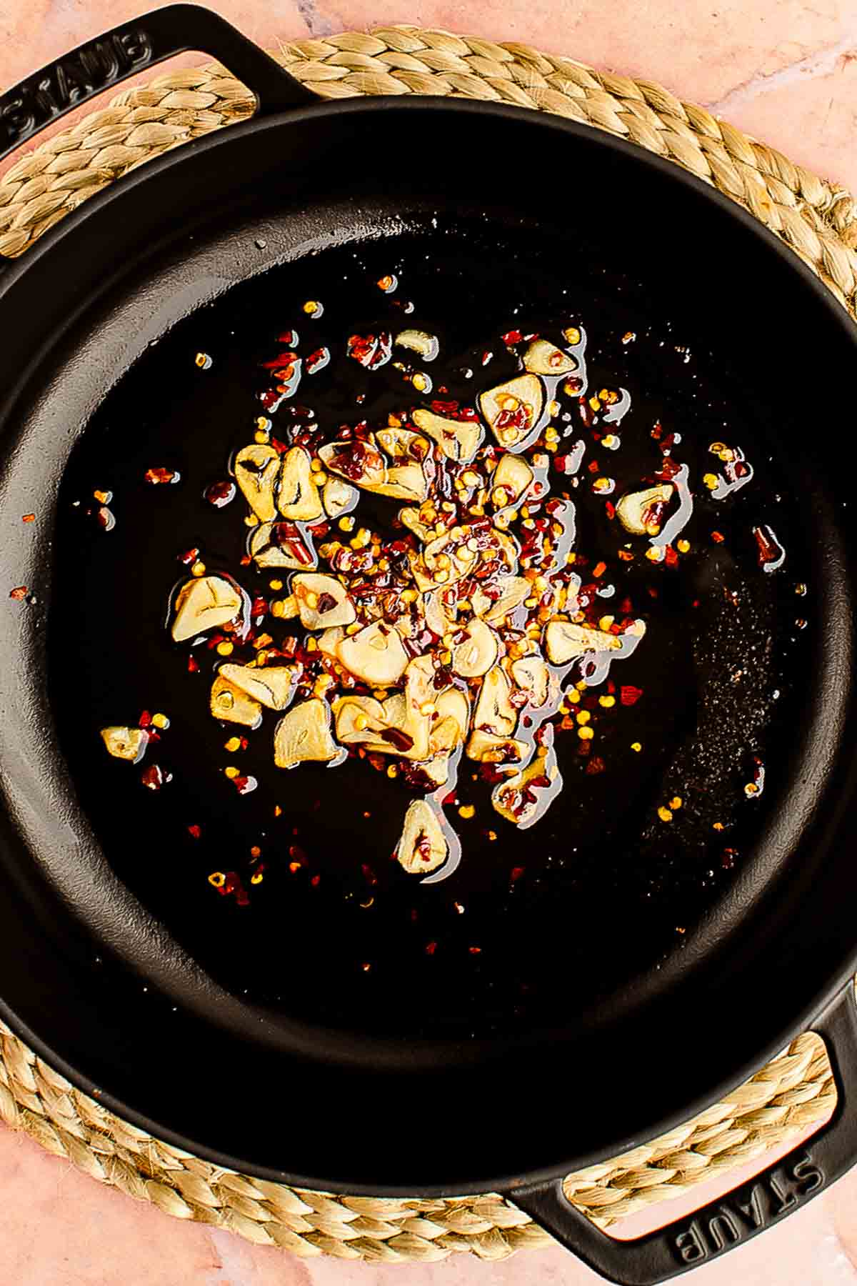 chopped garlic and red pepper flakes added to the hot skillet with sun dried tomato oil