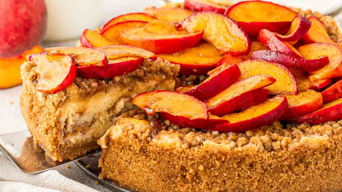 Peach cobbler cheesecake with roasted peaches and cinnamon streusel topping
