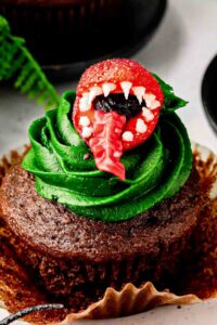 Top strawberry on Audrey II cupcakes