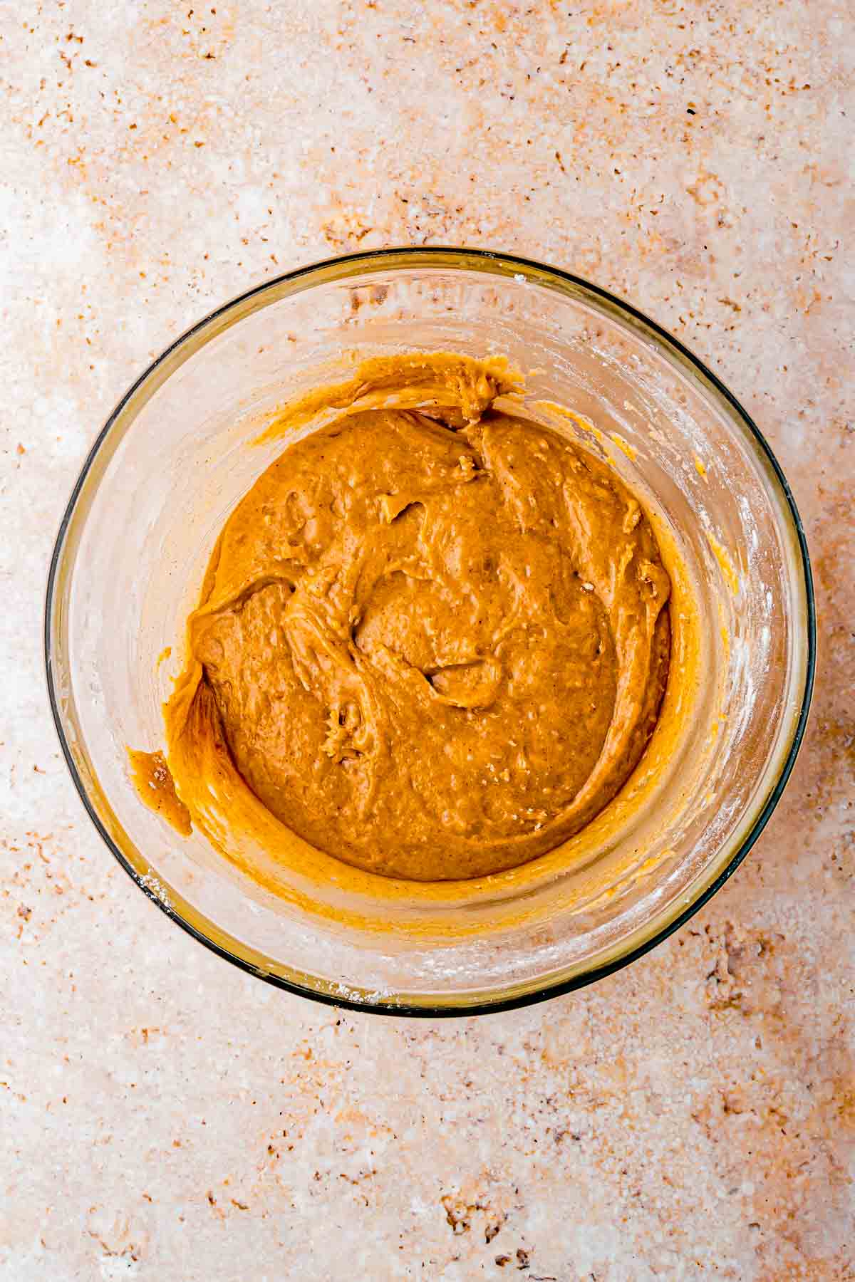 freshly grated carrots folded in together with dry and wet ingredients in the bowl