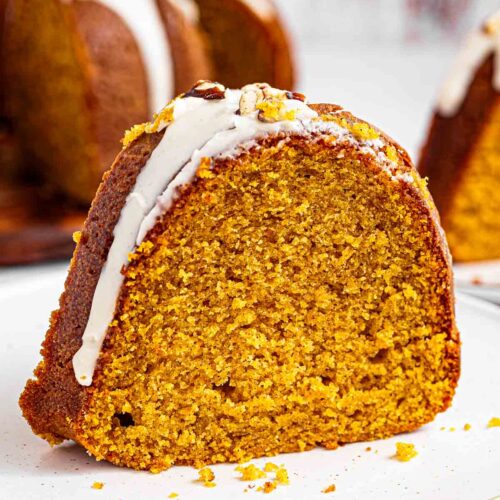 Extra moist pumpkin bundt cake topped with maple glaze and toasted pecans is easy to make and tastes like the holidays. It's a simple, homemade dessert packed with real pumpkin puree and filled with warm pumpkin pie spices: cinnamon, nutmeg, ginger, and cloves.