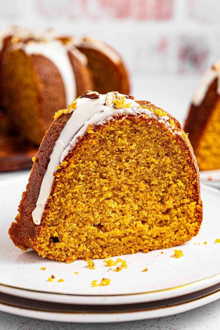 Extra moist pumpkin bundt cake topped with maple glaze and toasted pecans is easy to make and tastes like the holidays. It's a simple, homemade dessert packed with real pumpkin puree and filled with warm pumpkin pie spices: cinnamon, nutmeg, ginger, and cloves.