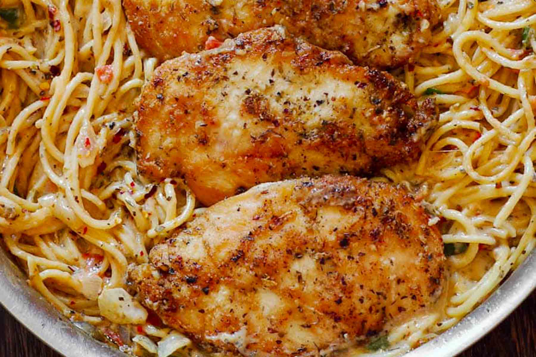 Creamy Italian chicken pasta in white wine parmesan sauce with golden seared chicken"