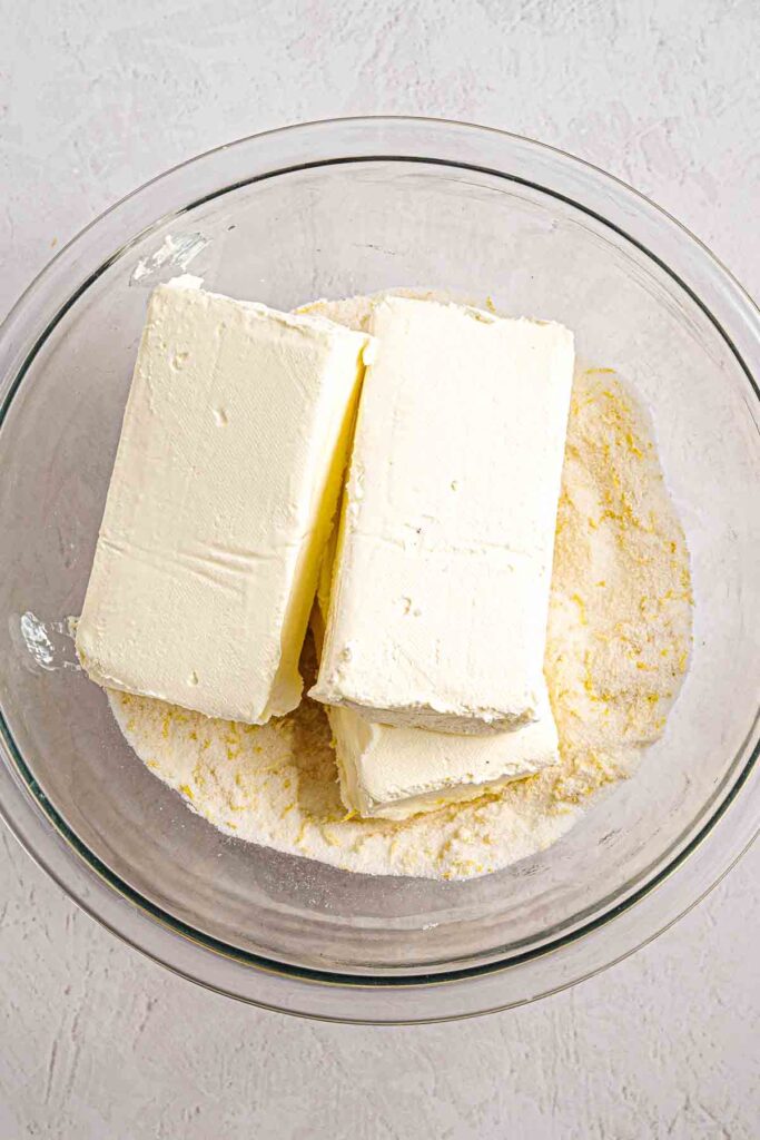 cream cheese mixed with sugar n the bowl for the cheesecake filling