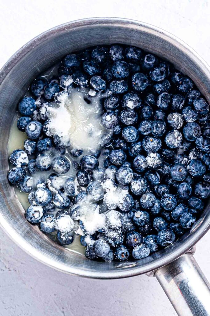 fresh blueberries with sugar before being boiled in the saucepan