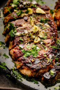 pan seared sirloin steak in cast iron skillet with garlic butter