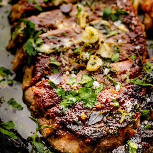 pan seared sirloin steak in cast iron skillet with garlic butter