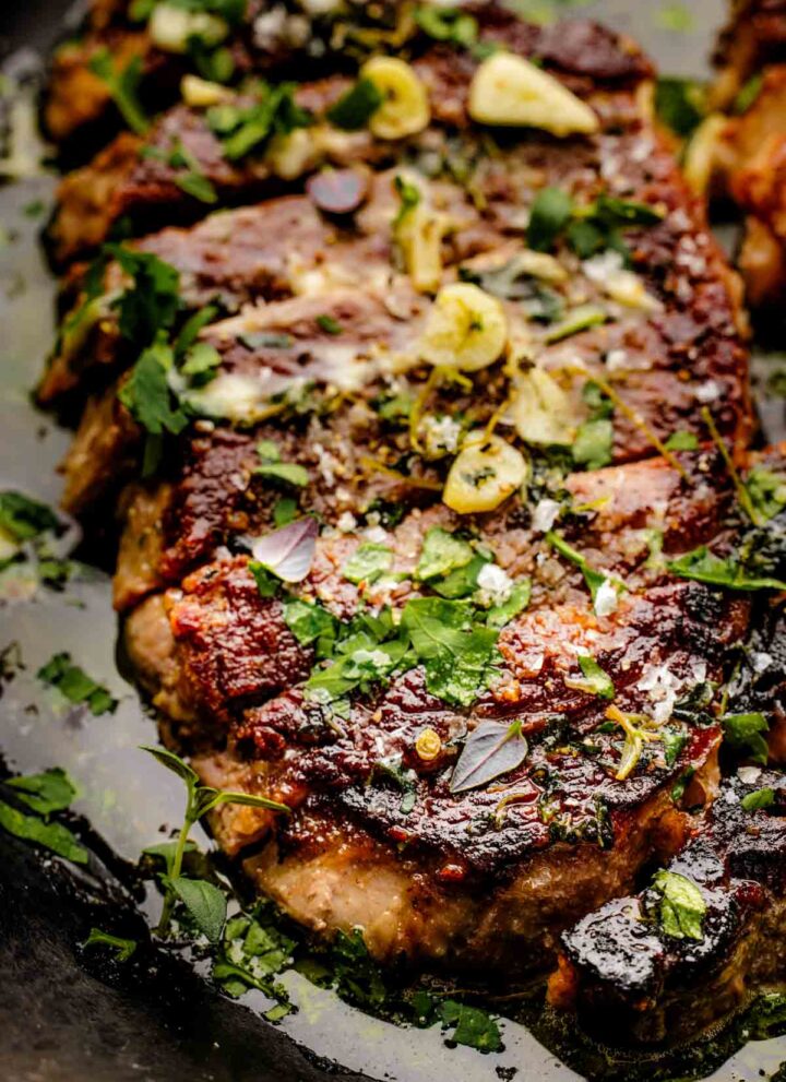 pan seared sirloin steak in cast iron skillet with garlic butter