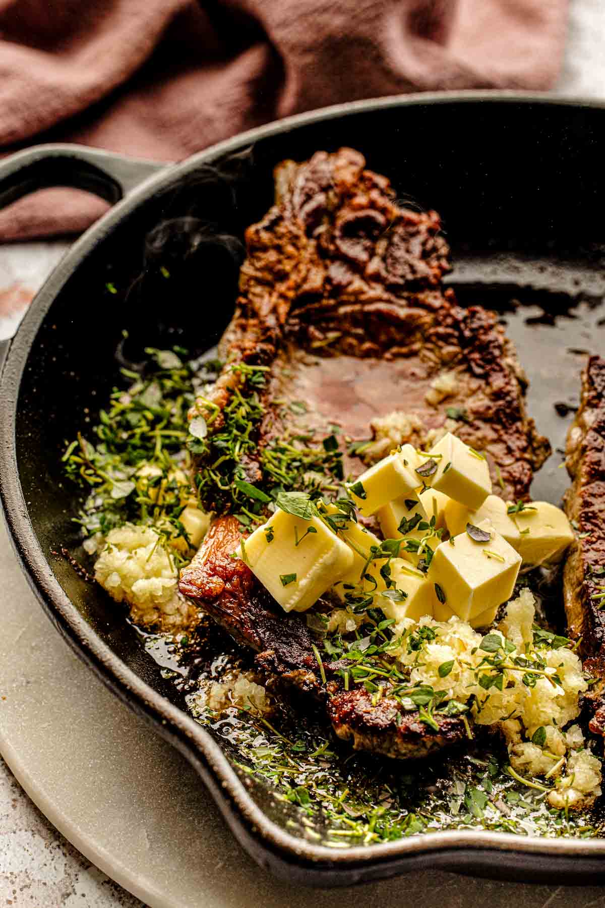 garlic butter spooned over the steak in cast iron pan