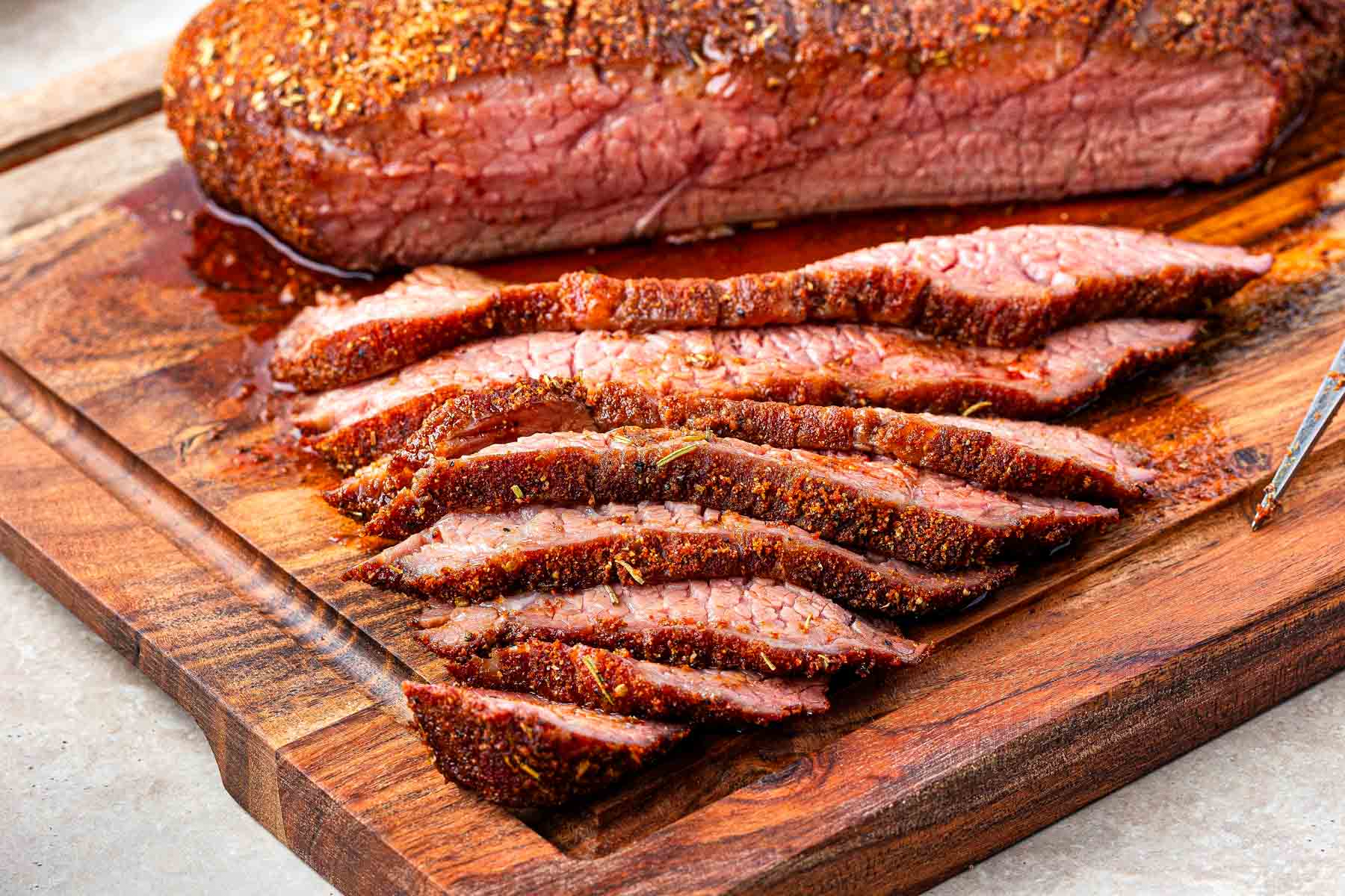 smoked tri tip on a cutting board