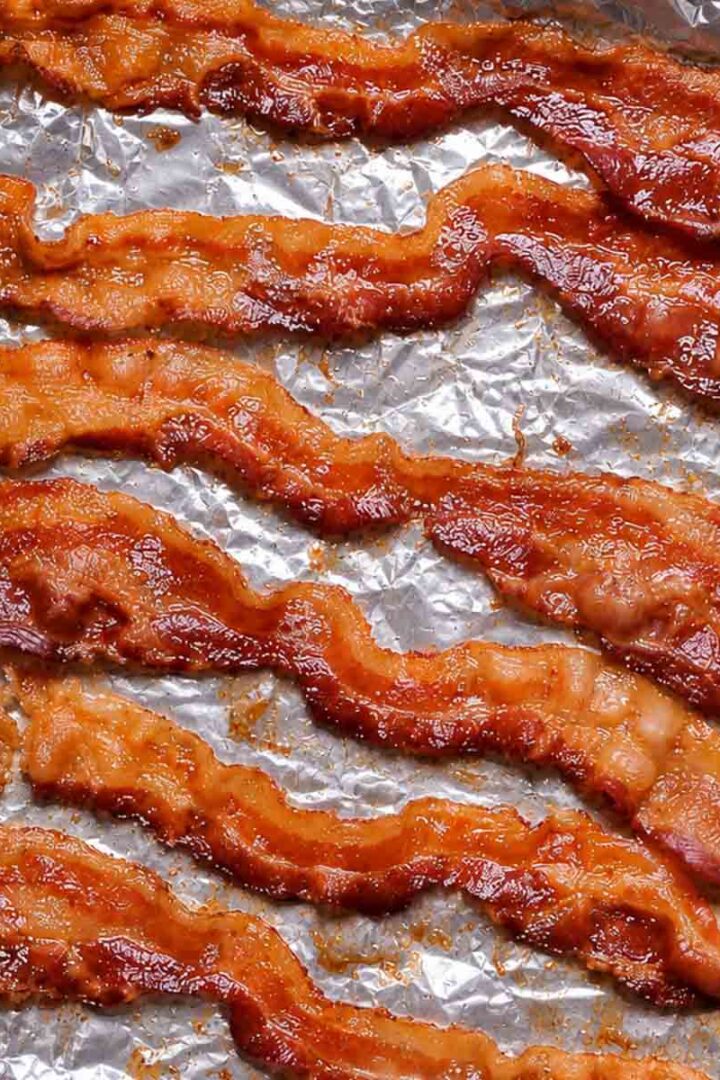 Cooked crispy bacon strips on foil