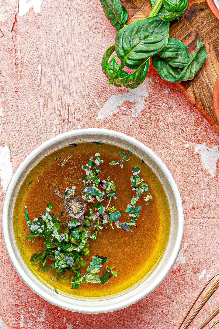 hot honey dressing in the bowl with herbs