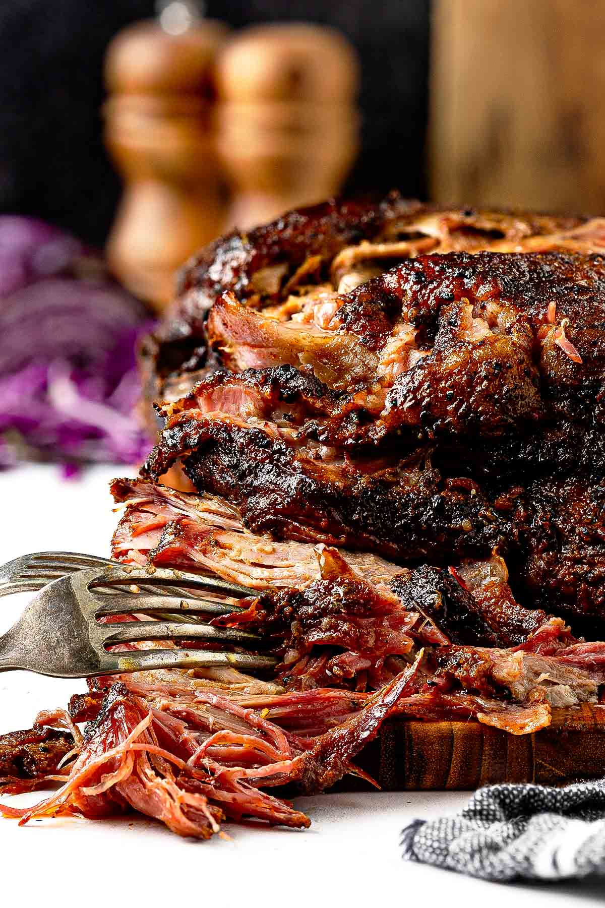 Smoked pulled pork piled high on a brioche bun with coleslaw — made from a low-and-slow Boston butt