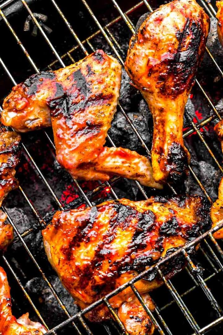 Overhead view of a tray of sweet and spicy grilled wings fresh off the grill, coated in thick glaze with visible grill marks.