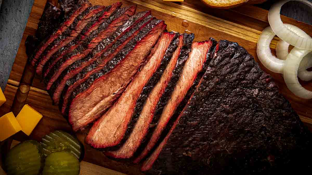 Close up of smoked brisket flat slices with near-black Hardcore Carnivore Black bark and pink smoke ring