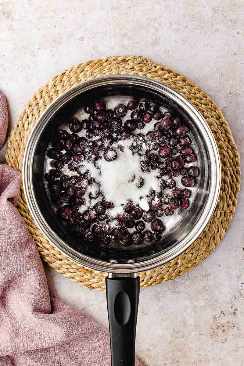 Cornstarch and water being whisked together in a small bowl to make a slurry for blueberry filling