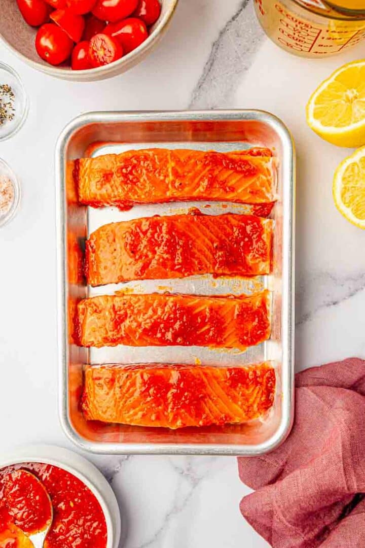 wild caught salmon filets before being baked on the baking sheet