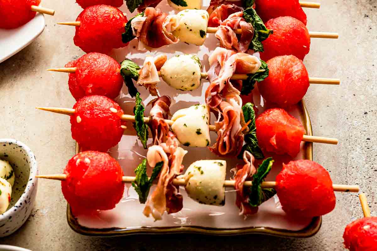 Watermelon Caprese Skewers on a plate