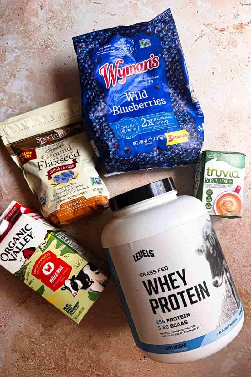 blueberry protein smoothie ingredients: wild blueberries, whey, flax seeds, sweetener and milk