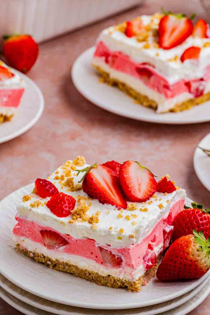 strawberry lasagna with 3 layers and sliced fresh strawberries on top