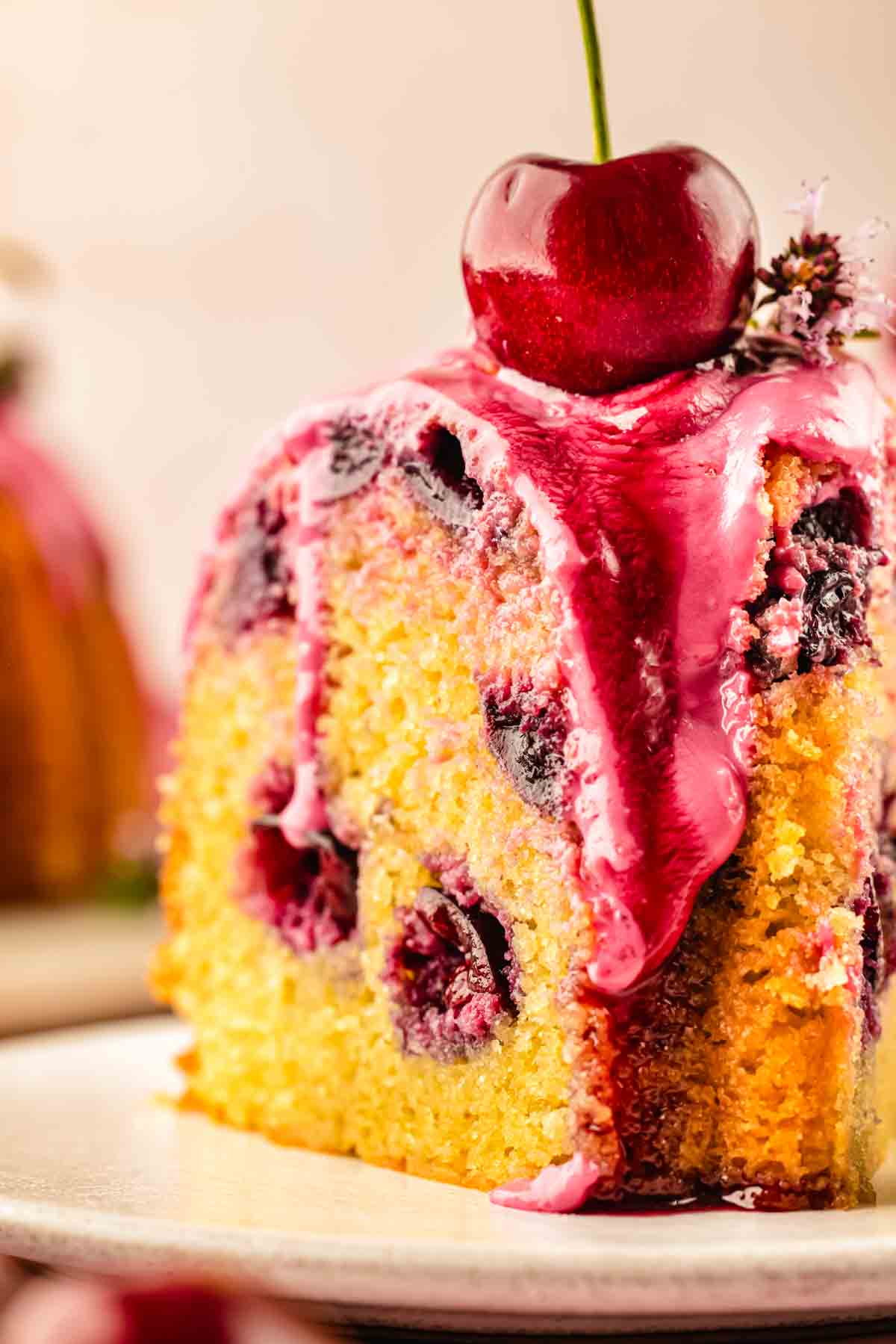 Close-up of moist cherry bundt cake crumb studded with fresh cherries and no sunken fruit at the base