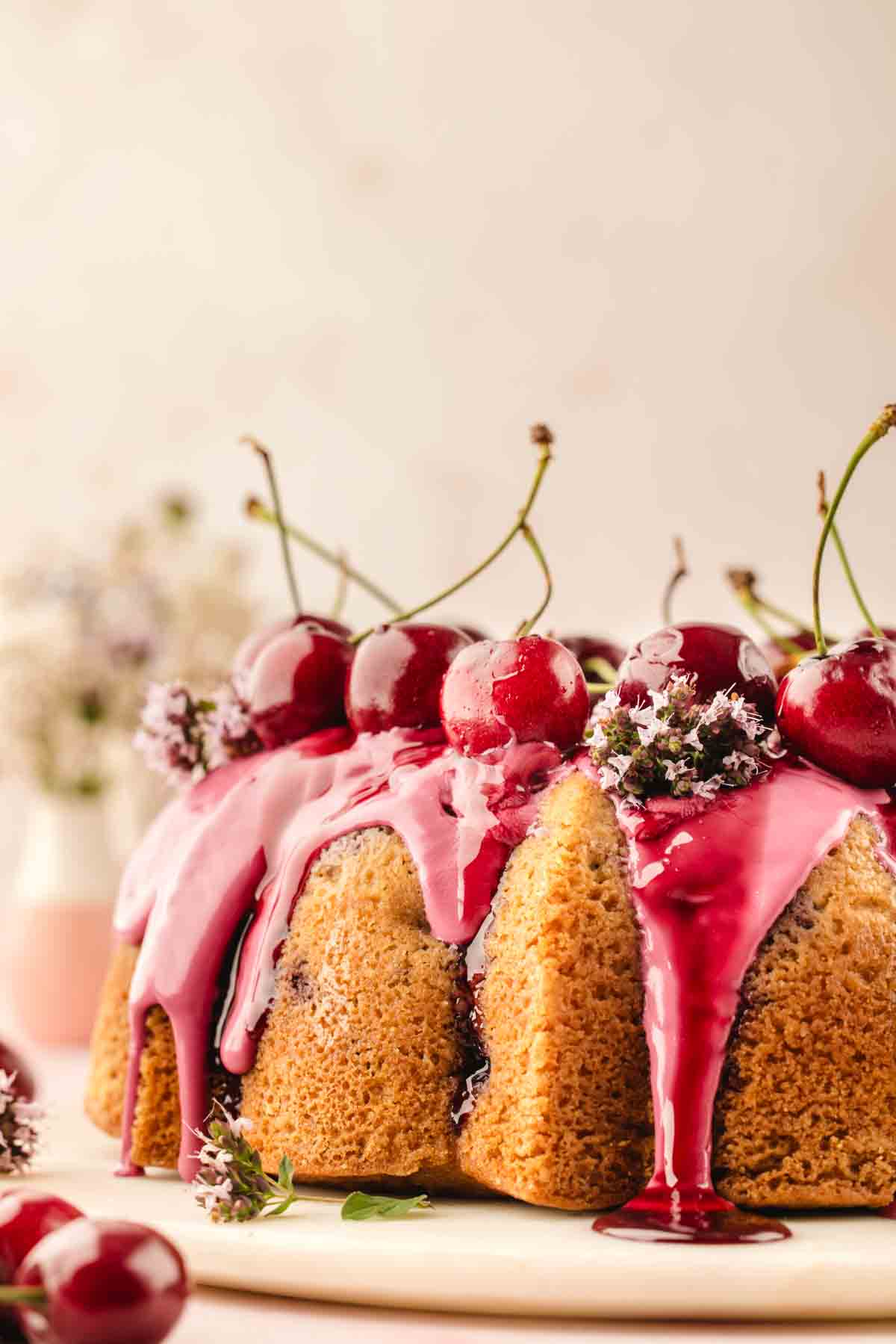 Fresh cherry bundt cake showing the iced ridges and cherry-studded interior