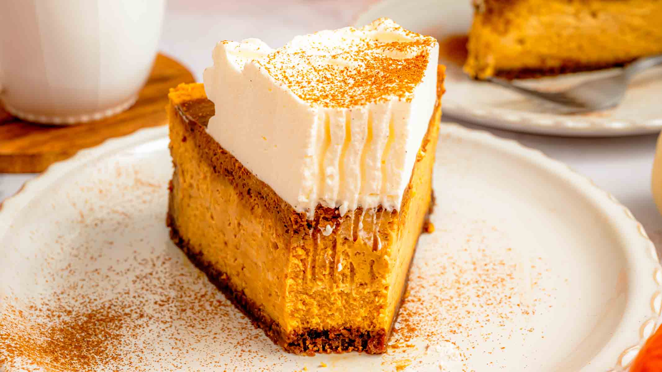I sliced my pumpkin spice latte cheesecake to show the espresso swirl running through the orange pumpkin filling