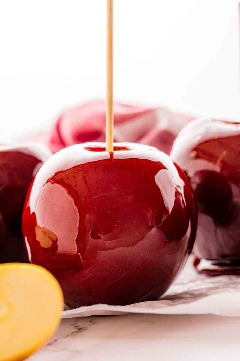 Close up of Toffee Apple on a stick with shatter proof glass shell