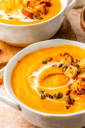 butternut squash pumpkin sweet potato soup with pumpkin seeds and toasted croutons on top