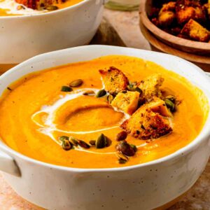 butternut squash pumpkin sweet potato soup with pumpkin seeds and toasted croutons on top