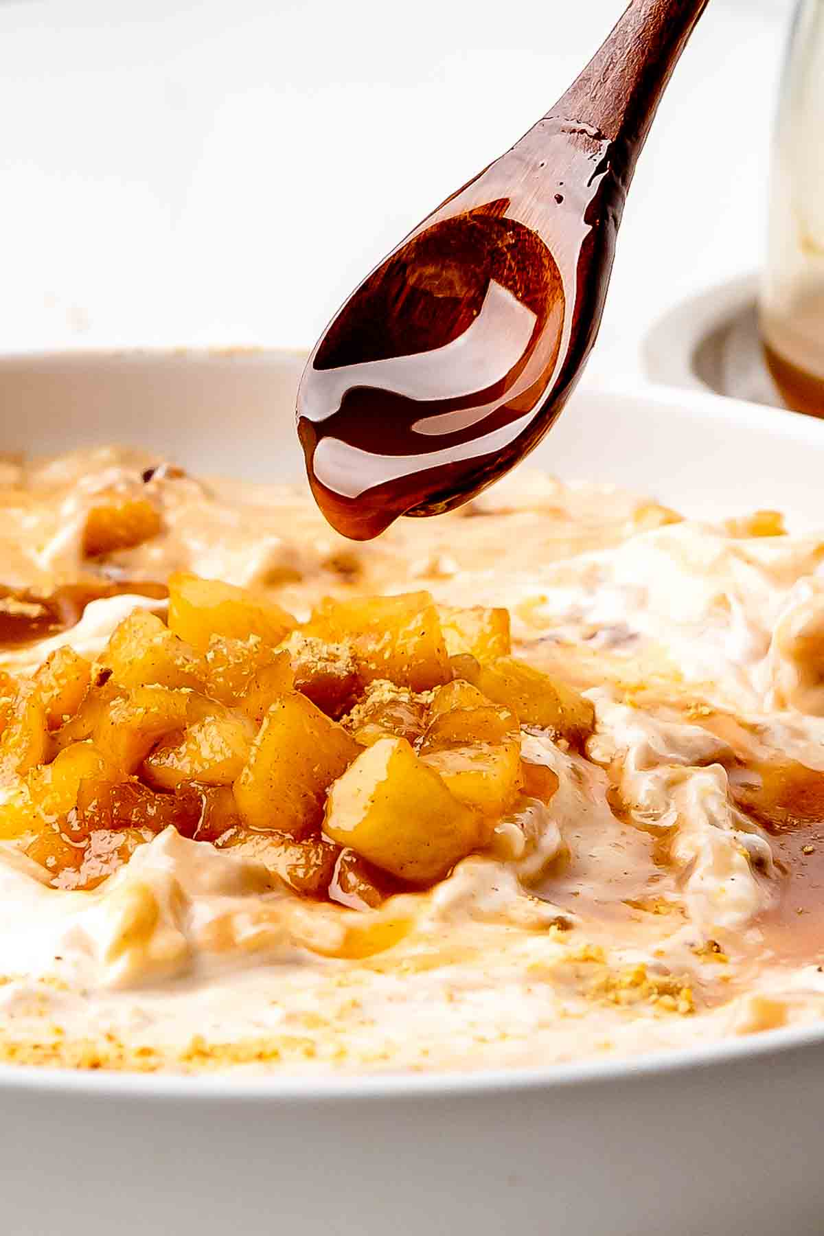 Caramel dripping from a spoon on the Apple Cheesecake Dip