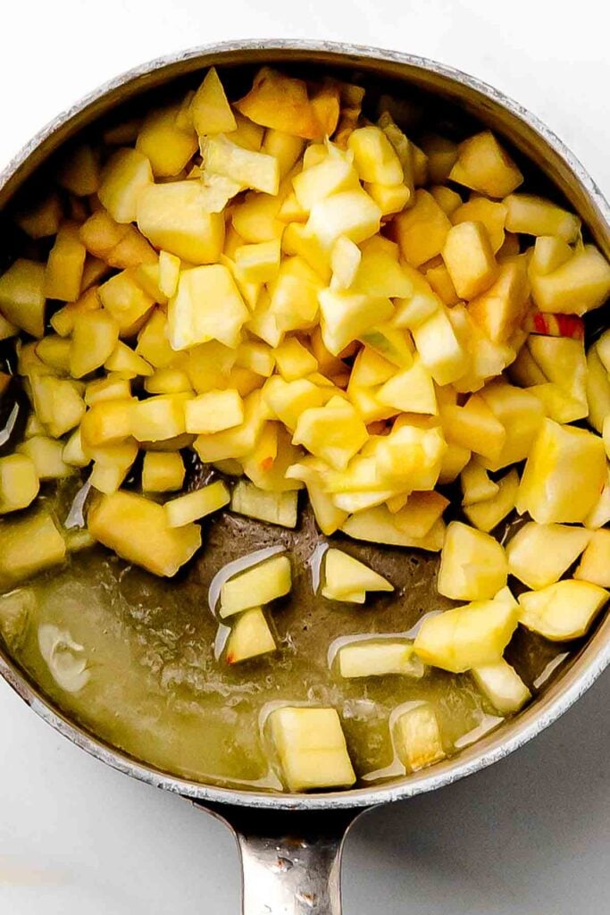 sliced apples in the pan before cooking