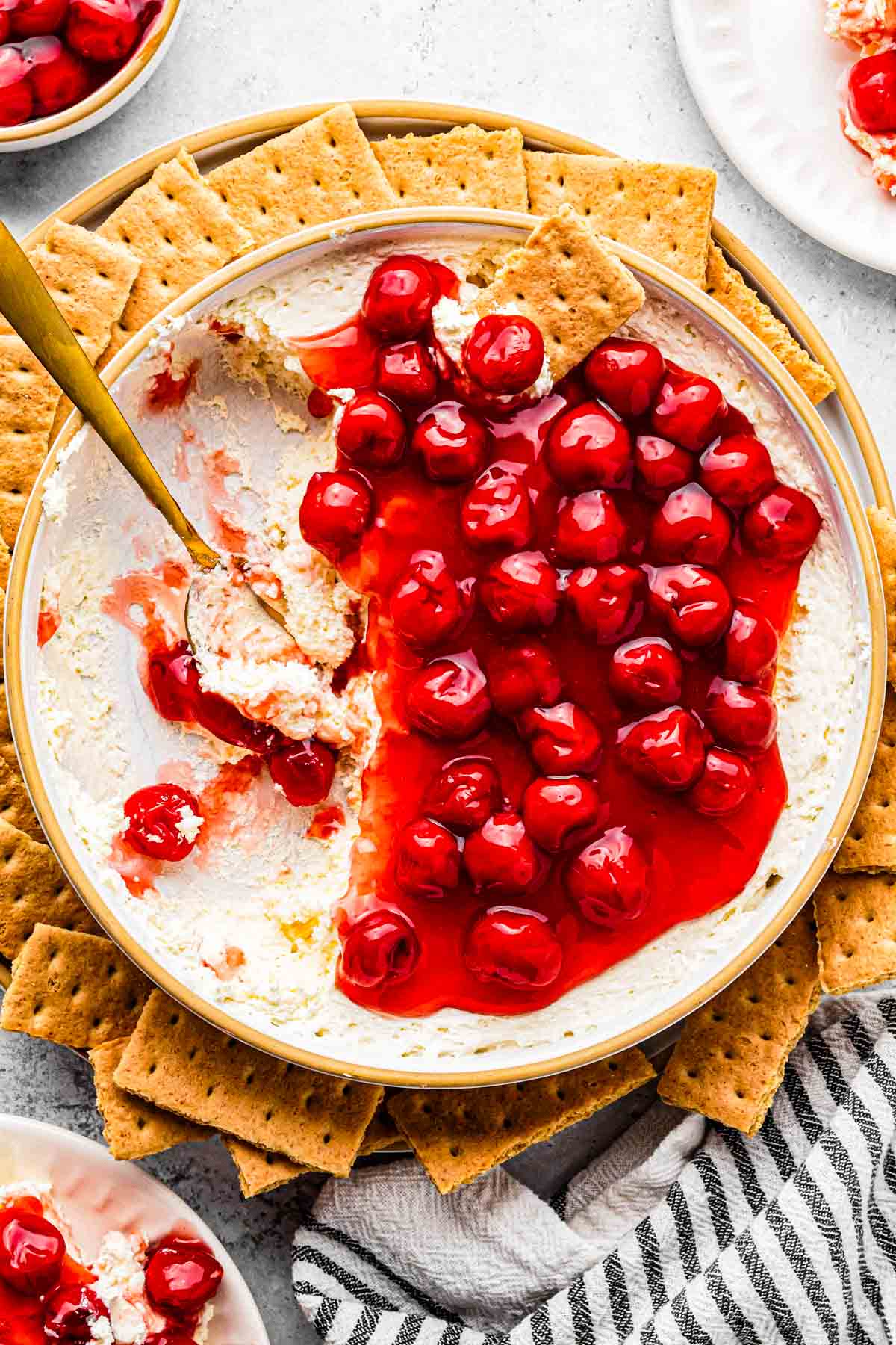 cherry cheesecake dip with crackers surrounding it