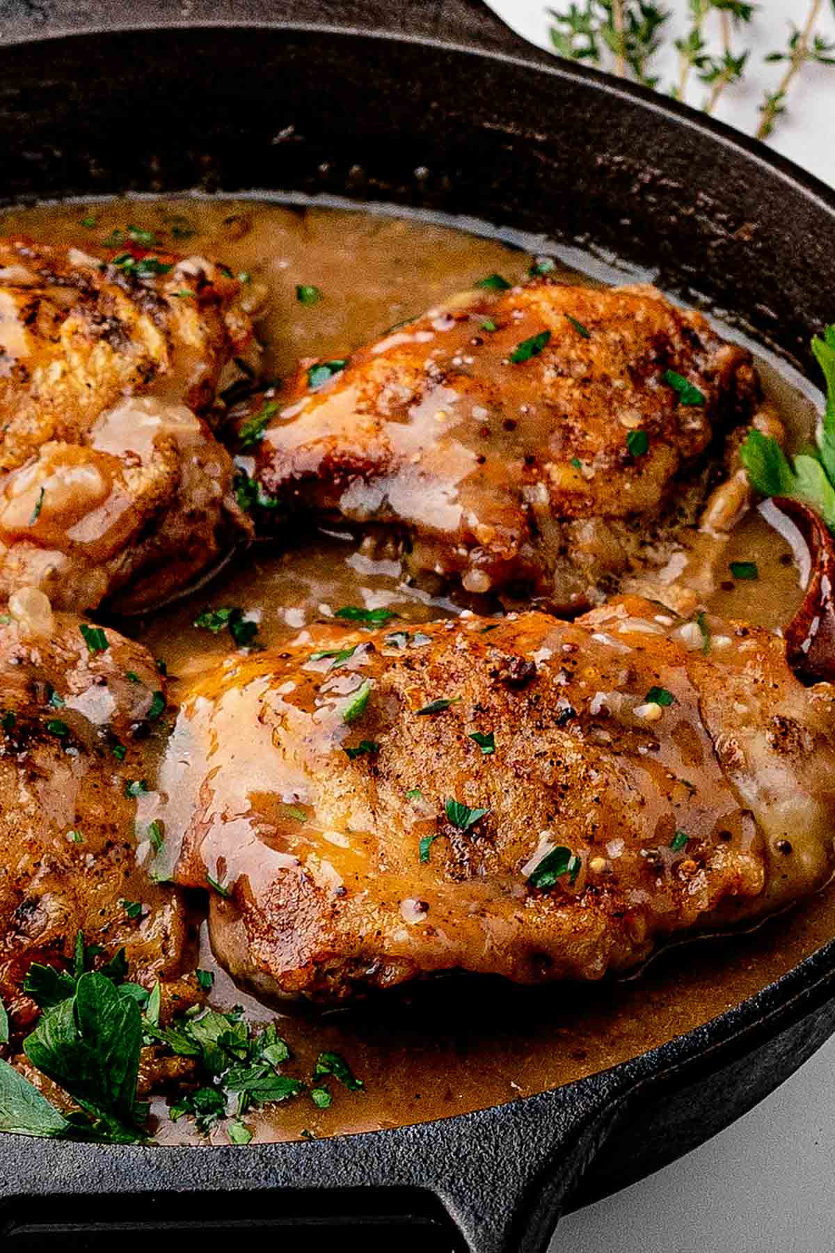 Beer Braised Chicken Thighs in cast iron skillet