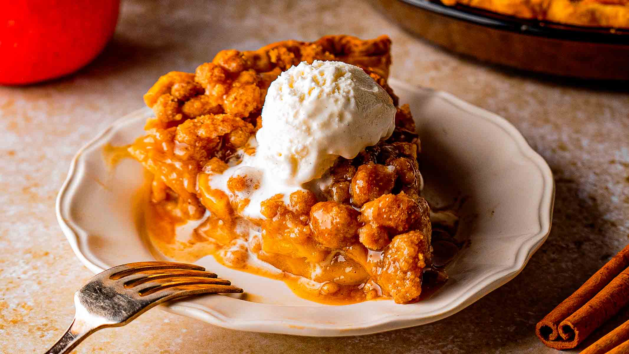 Dutch caramel apple pie with golden brown crumble topping and caramel drizzle